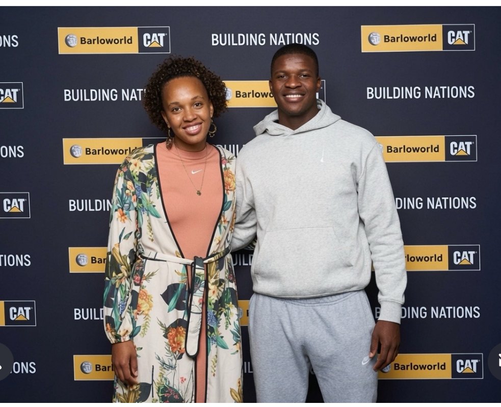 Mbekezeli Mbokazi with his QT Sports agent at the Barloworld Building Nations wall